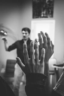A student raising a hand during a classroom discussion